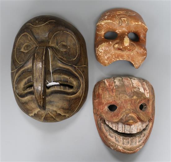 A North West American mask and two Asian masks Largest length 28.5cm